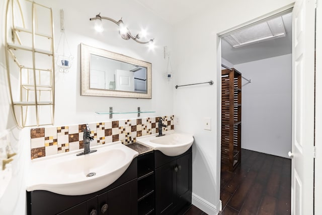 bathroom with decorative backsplash, vanity, and hardwood / wood-style flooring