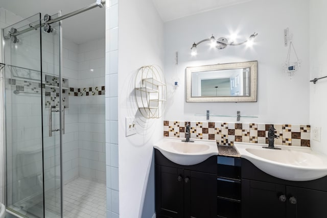 bathroom featuring backsplash, vanity, and an enclosed shower