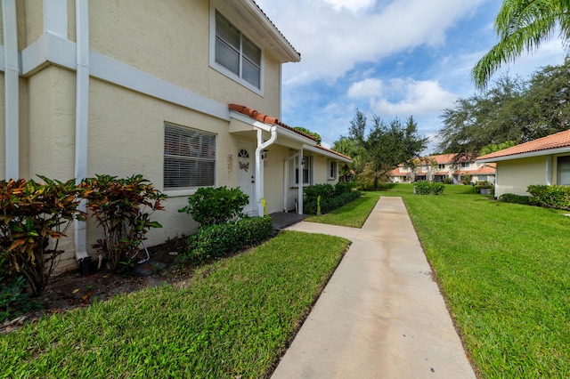 view of side of home with a yard