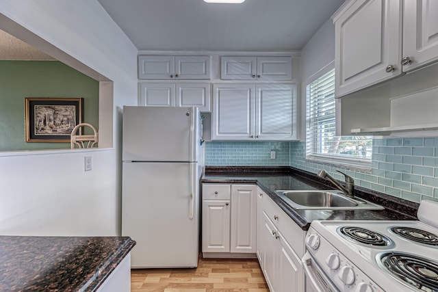 kitchen featuring decorative backsplash, white appliances, sink, light hardwood / wood-style flooring, and white cabinetry