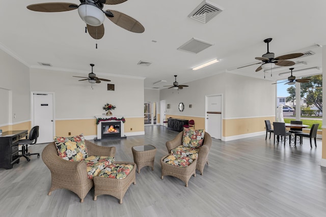 living room featuring light hardwood / wood-style flooring and ornamental molding