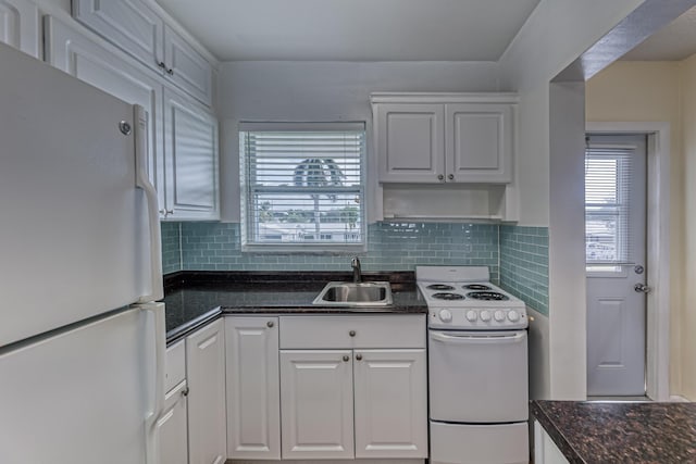 kitchen with plenty of natural light, white cabinetry, white appliances, and sink