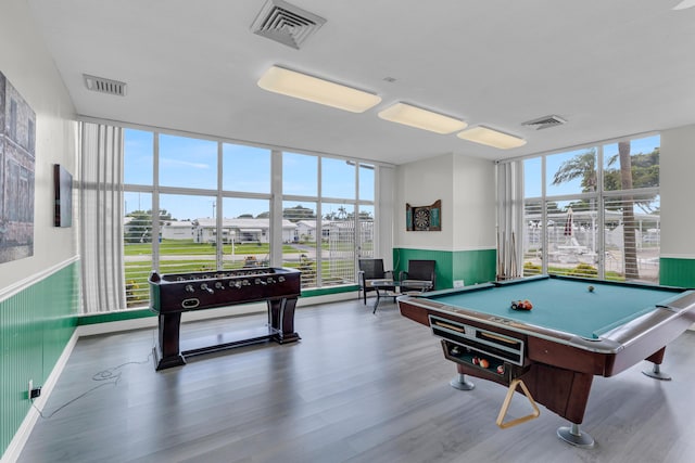 rec room with hardwood / wood-style flooring, a wall of windows, and billiards