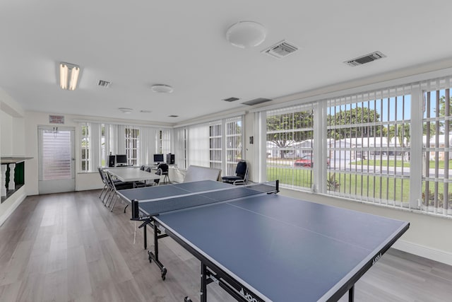 game room with light hardwood / wood-style floors