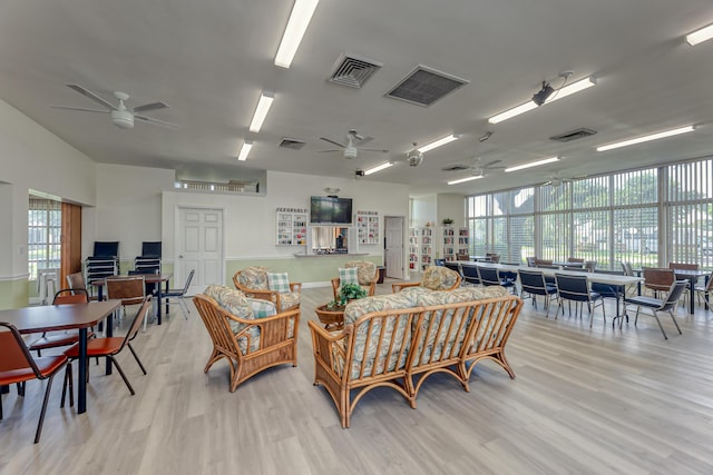 living room featuring light hardwood / wood-style floors, plenty of natural light, and ceiling fan