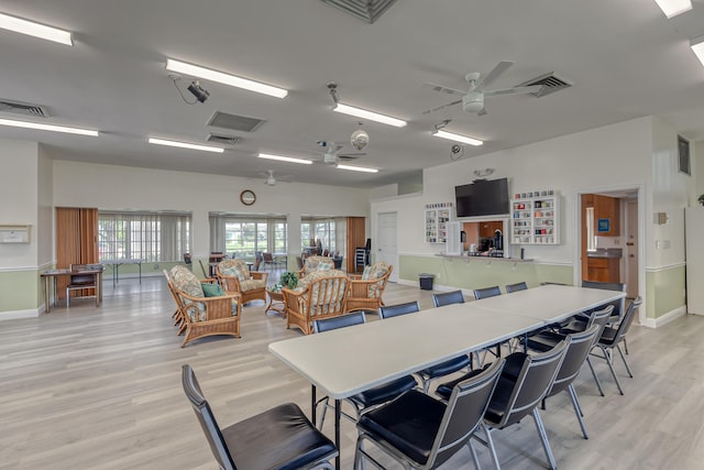 dining space with light hardwood / wood-style flooring and ceiling fan