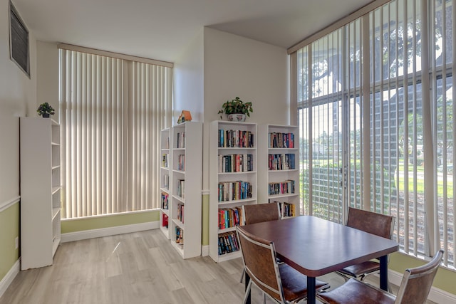 dining room featuring light wood-type flooring and a healthy amount of sunlight