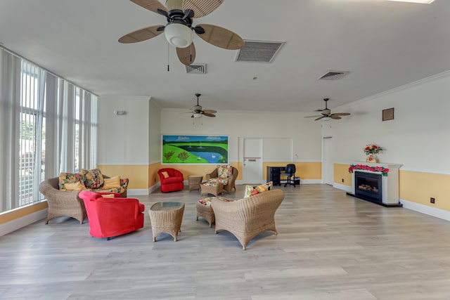 living room featuring light hardwood / wood-style floors and ornamental molding