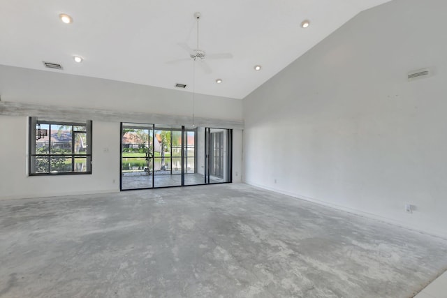 empty room with ceiling fan, high vaulted ceiling, and concrete floors