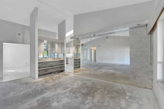 garage featuring high vaulted ceiling