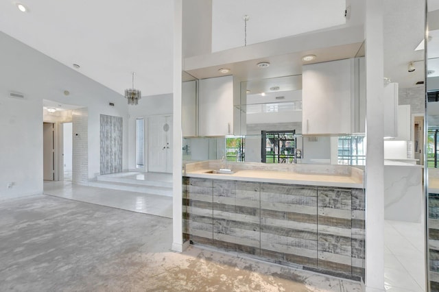 kitchen with sink and high vaulted ceiling