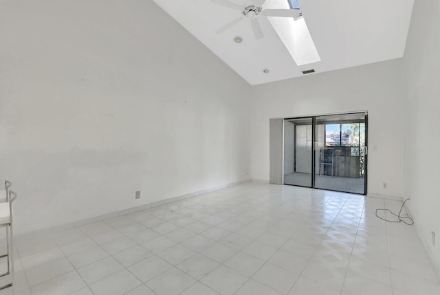 unfurnished room featuring a skylight, high vaulted ceiling, and ceiling fan