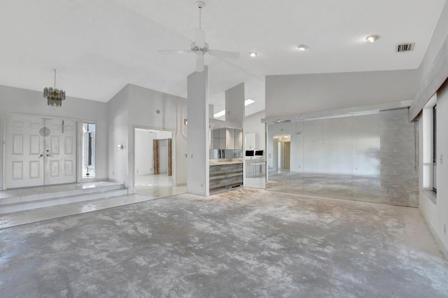 unfurnished living room with ceiling fan, high vaulted ceiling, and concrete flooring