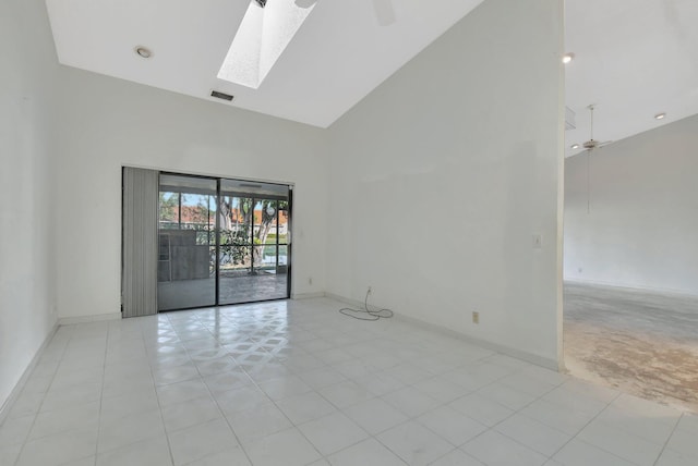 unfurnished room featuring high vaulted ceiling, ceiling fan, and a skylight