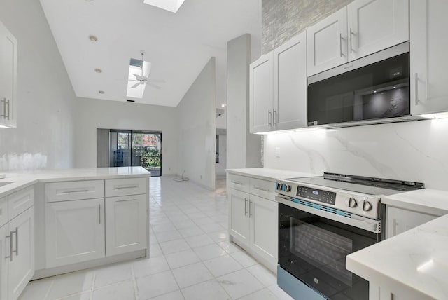 kitchen featuring lofted ceiling, white cabinets, decorative backsplash, ceiling fan, and stainless steel appliances