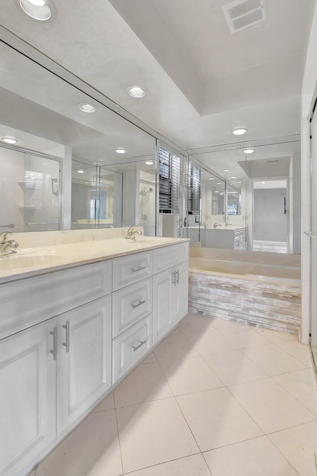 bathroom with vanity, tile patterned floors, and plus walk in shower