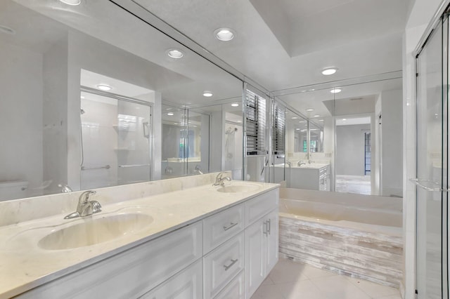 bathroom with tile patterned floors, vanity, and plus walk in shower