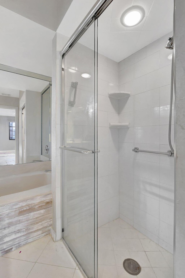 bathroom with tile patterned floors and a shower with shower door