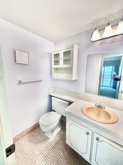 bathroom with tile patterned flooring, vanity, and toilet