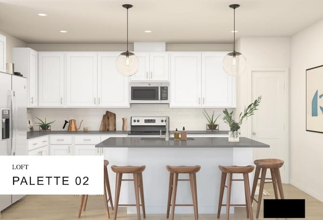 kitchen with white cabinets, pendant lighting, and stainless steel appliances