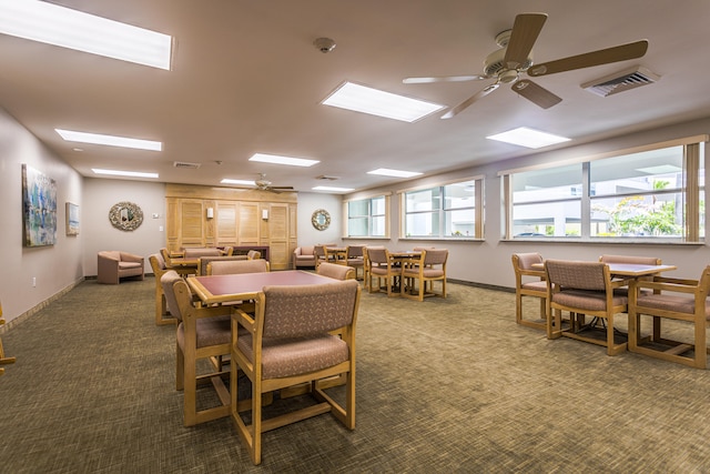 carpeted dining room featuring ceiling fan