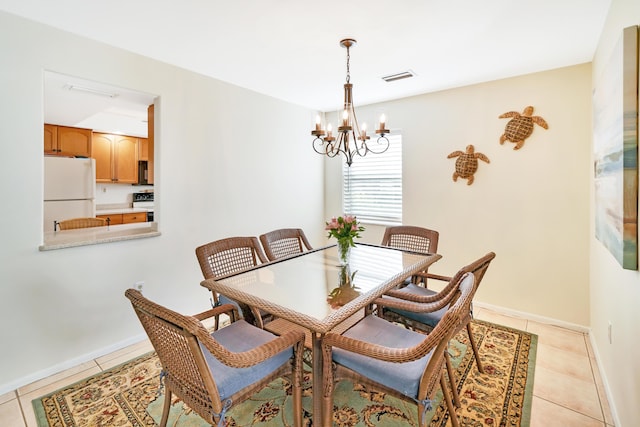 dining space with a notable chandelier and light tile patterned floors