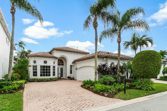 mediterranean / spanish-style house with a garage