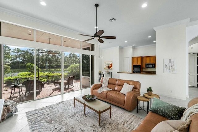 tiled living room with ceiling fan and ornamental molding