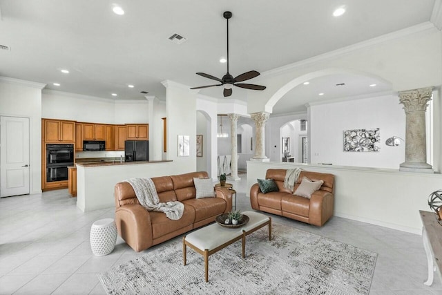 living room featuring light tile patterned floors, ornate columns, ceiling fan, and crown molding