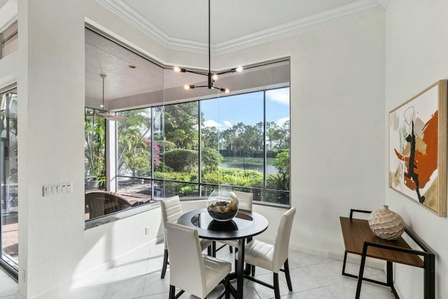 tiled dining area with ornamental molding and a healthy amount of sunlight