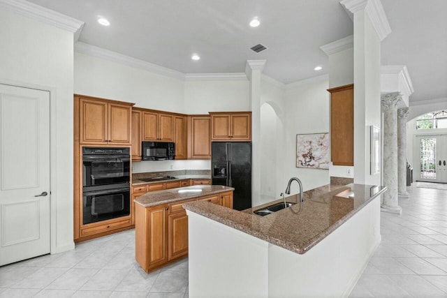 kitchen with kitchen peninsula, ornamental molding, dark stone counters, sink, and black appliances