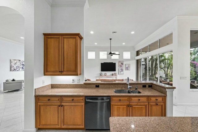 kitchen featuring stone countertops, stainless steel dishwasher, crown molding, and sink