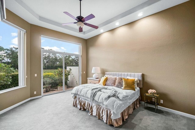 carpeted bedroom with ceiling fan, access to outside, and multiple windows