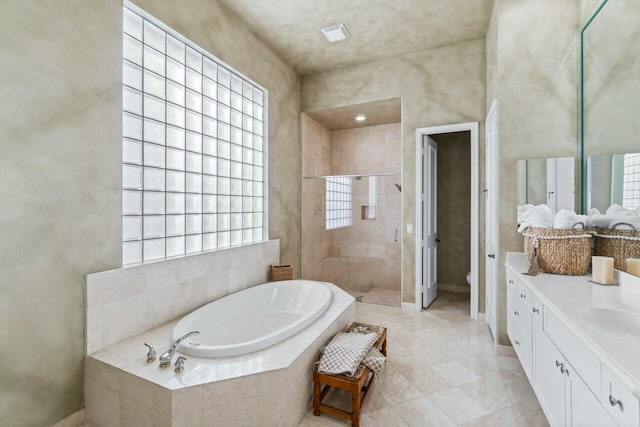 full bathroom featuring toilet, vanity, and separate shower and tub