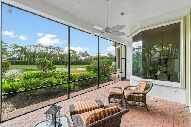 sunroom / solarium featuring ceiling fan