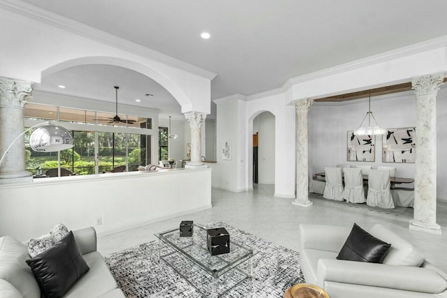 tiled living room featuring ceiling fan with notable chandelier and crown molding