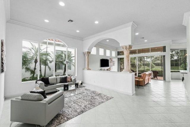 living room with ornate columns, ornamental molding, and light tile patterned floors