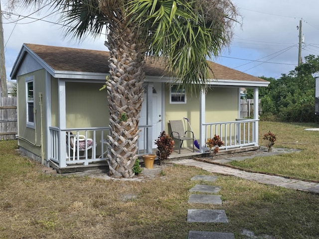 bungalow-style home with a porch and a front lawn