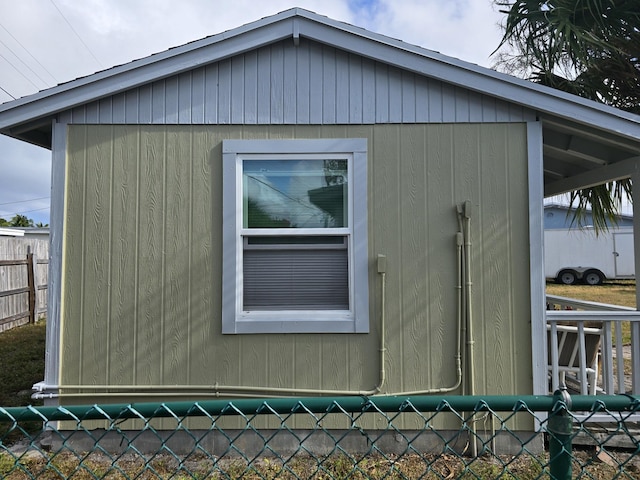 view of side of home with a storage shed