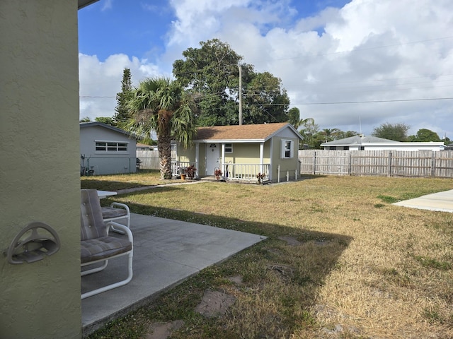 view of yard featuring an outbuilding and a patio