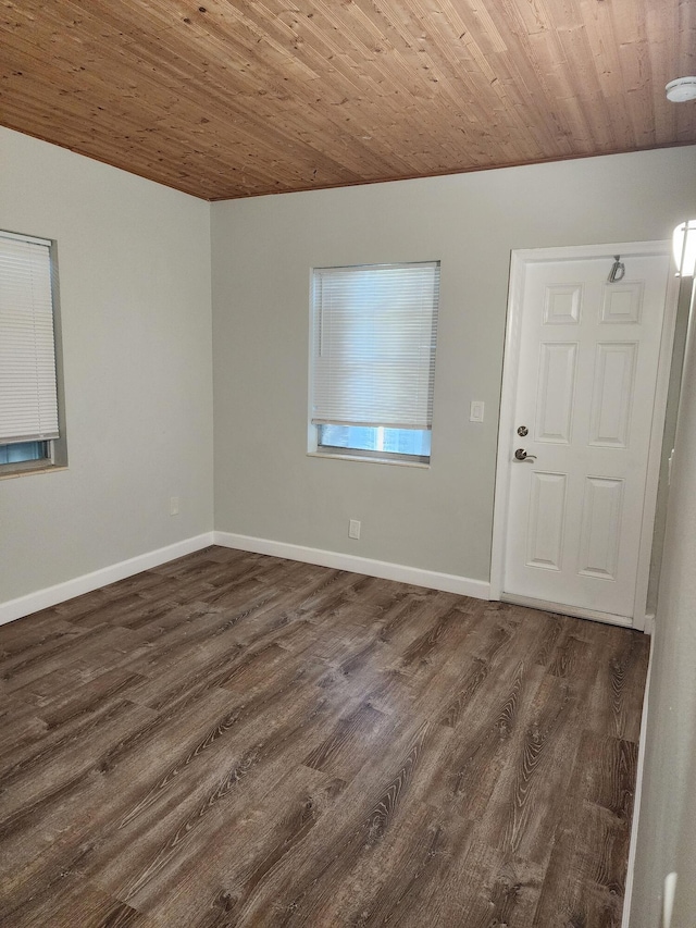 unfurnished room featuring wood ceiling and dark wood-type flooring