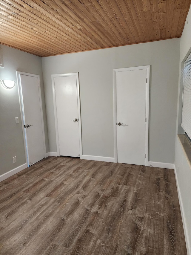 unfurnished room featuring wood ceiling and hardwood / wood-style flooring