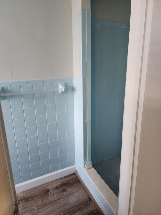 bathroom featuring tiled shower and hardwood / wood-style flooring