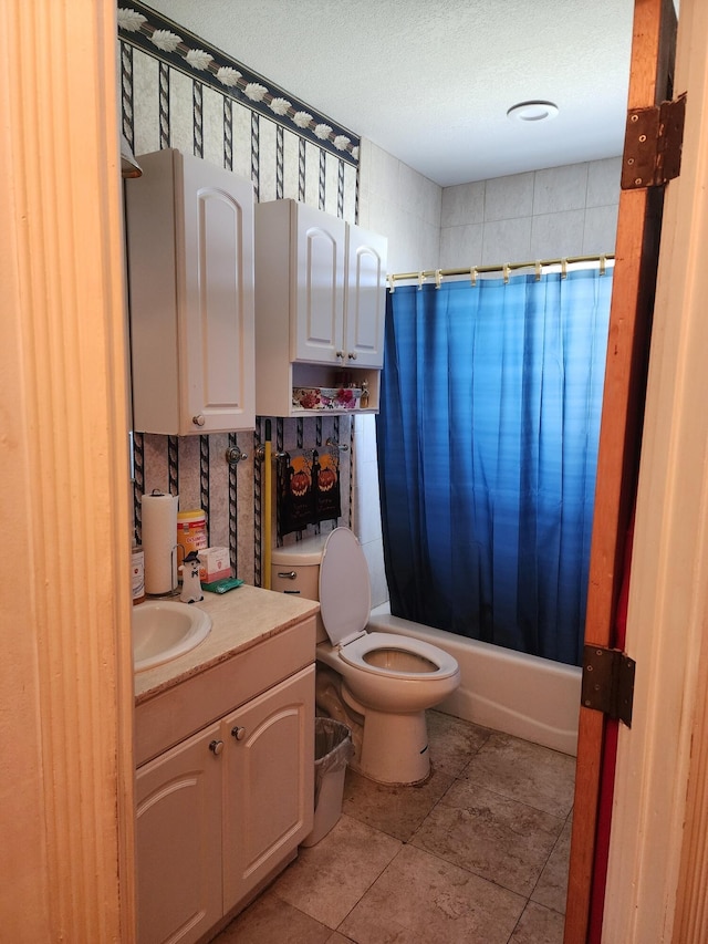 full bathroom featuring vanity, tile patterned flooring, toilet, shower / bathtub combination with curtain, and a textured ceiling