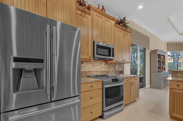 kitchen featuring light stone countertops, appliances with stainless steel finishes, light brown cabinetry, tasteful backsplash, and light tile patterned flooring