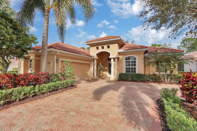 mediterranean / spanish-style home with a garage