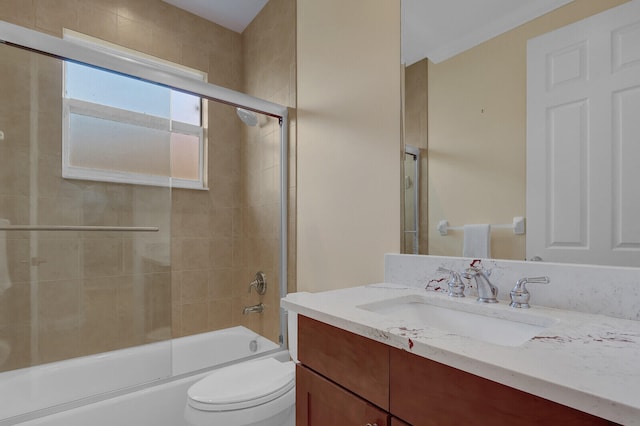 full bathroom with shower / bath combination with glass door, vanity, and toilet