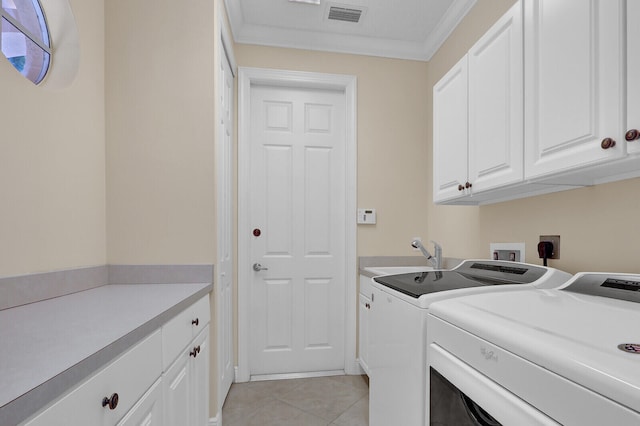 washroom featuring sink, cabinets, light tile patterned floors, washer and dryer, and ornamental molding