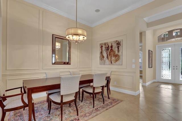 dining space featuring a chandelier, french doors, tile patterned floors, and ornamental molding