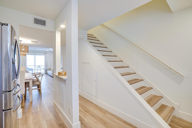 stairs with hardwood / wood-style floors